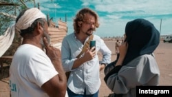 American journalist Stavros Nicolas Niarchos, center, is seen conducting an interview in a photo posted on his Instagram (@apostcardfromthevolcano).