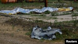 Burnt bodies of detainees lie covered following the shelling at a pre-trial detention center in the course of Ukraine-Russia conflict, in the settlement of Olenivka in the Donetsk Region, Ukraine July 29, 2022.