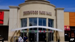 FILE - Shoppers leave the Greenwood Park Mall, in Greenwood, Indiana, May 4, 2020. The mall was the site of a deadly shooting Sunday.