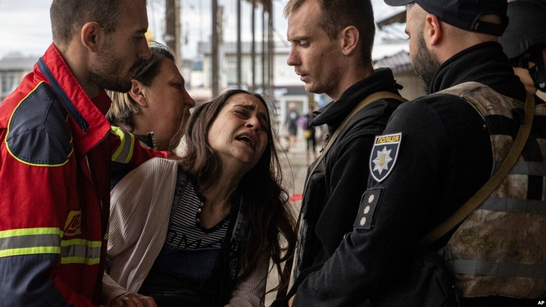A woman cries after her husband was killed by Russian shelling at Barabashovo market in Kharkiv, Ukraine, July 21, 2022.