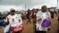 Supporters hold posters to celebrate the victory of opposition candidate Ademola Adeleke, following the conclusion of state gubernatorial elections, in Ido Oshun, Osun state, in southwest Nigeria, July 17, 2022.