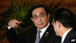 FILE - Thai Prime Minister Prayut Chan-ocha, left, speaks to Japanese Prime Minister Fumio Kishida after their meeting in Tokyo, May 26, 2022.