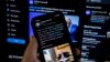 In this photo illustration taken on July 21, 2022, a tweet from U.S. President Joe Biden saying "Folks, I'm doing great" is seen on a cell phone with a breaking news alert that the president has positive for the coronavirus.