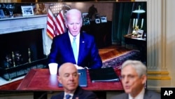President Joe Biden listens virtually as Attorney General Merrick Garland, right, speaks at a meeting on reproductive health care access, in the Eisenhower Executive Office Building in Washington, Aug. 3, 2022. Homeland Security Secretary Alejandro Mayorkas looks on.