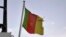 FILE - A Cameroonian flag flies on a ship at the port in Douala, Cameroon. Taken April 10, 2022.