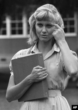 FILE - Olivia Newton-John readies herself for her role in the movie version of "Grease," in Los Angeles, Aug. 30, 1977.