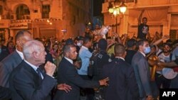 A handout picture provided by the Tunisian presidency press service shows President Kais Saied celebrating with his supporters on Habib Bourguiba Avenue in Tunis, July 26, 2022 after the projected outcome was announced. (Photo by Tunisian Presidency / AFP