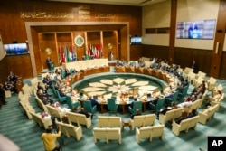 FILE - In this handout photo released by Russian Foreign Ministry Press Service, Russian Foreign Minister Sergey Lavrov, background left, addresses the Arab League organization in Cairo, Egypt, July 24, 2022.