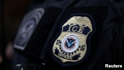 FILE - The badge of a field office director for the U.S. Immigration and Customs Enforcement's (ICE) Enforcement and Removal Operations in Hawthorne, California, on March 1, 2020.