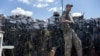 A Ukrainian soldier, accompanied by a dog, keeps position on the front line in Mykolaiv region on July 23, 2022, amid the Russian invasion of Ukraine.