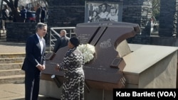 U.S. Secretary of State Antony Blinken, left, speaks with Antoinette Sithole, the sister of the late Hector Pieterson after they laid a wreath at the Hector Pieterson Memorial in Soweto, South Africa, Aug. 7, 2022.