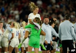 FILE - England players celebrate at the end of the Women Euro 2022 semi final soccer match between England and Sweden at Bramall Lane Stadium in Sheffield, England, July 26, 2022.