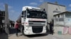 Hamas police officers check a tanker truck carrying fuel as it is cleared to enter the Palestinian side of the Kerem Shalom cargo crossing with Israel, in Rafah, southern Gaza Strip, Aug. 8, 2022. 