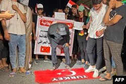 Iraqis protest against Turkey's military offensive in Iraq's autonomous Kurdistan region, in front of a Turkish visa center in the central Iraqi city of Karbala, July 20, 2022.