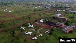 This file photo shows a community learning center established by artist Ibrahim Mahama in his birthplace village of Jenakpeng. Mahama recently added six old airplanes, shown in the image, to the center. (Reuters from video)