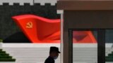 FILE - A security guard stands near a sculpture of the Chinese Communist Party flag at the Museum of the Communist Party of China on May 26, 2022, in Beijing. 