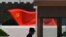FILE - A security guard stands near a sculpture of the Chinese Communist Party flag at the Museum of the Communist Party of China on May 26, 2022, in Beijing. 