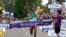 Tamirat Tola, of Ethiopia, celebrates as he crosses the finish line in the men's marathon at the World Athletics Championships in Eugene, Oregon, July 17, 2022. 