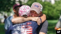 Activist and entertainer Jon Stewart hugs fellow advocate Susan Zeier after learning that the Senate would vote on a bill designed to help veterans exposed to toxic substances during their military service, at the Capitol in Washington, Aug. 2, 2022.