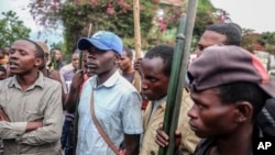 FILE - Demonstrators face police during a protest against the United Nations peacekeeping force (MONUSCO) deployed in the Democratic Republic of the Congo in Sake, some 24 kilometers west of Goma, July 27, 2022.