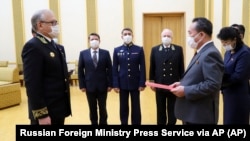 FILE - Russian Ambassador to North Korea Alexander Matsegora, pictured at left during a ceremony on May 5, 2020, said in an interview with a Russian newspaper on July 19 that Moscow could hire North Korean workers to rebuild Ukraine's war-ruined Donbas region.