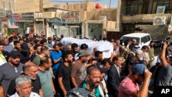 The coffin carrying Abbas Abdul Hussein, a 30-year-old victim of an artillery strike, is carried to his family home in Baghdad, to later lay him to rest in Najaf city, July 21, 2022, in Baghdad, Iraq.