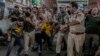 Indian policemen detain Kashmiri Shiite Muslims for participating in a religious procession during restrictions in Srinagar, Indian controlled Kashmir, Aug. 7, 2022. 