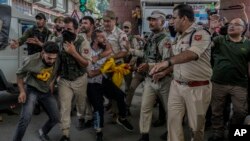 Indian policemen detain Kashmiri Shiite Muslims for participating in a religious procession during restrictions in Srinagar, Indian controlled Kashmir, Aug. 7, 2022. 