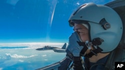 In this photo released by Xinhua News Agency, a Chinese air force pilot conducts a combat training exercises around the Taiwan Island, Aug. 7, 2022.