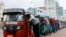 Drivers push auto rickshaws in a line to buy petrol from a fuel station, amid Sri Lanka's economic crisis, in Colombo, Sri Lanka.