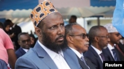 FILE - Former al-Shabaab group co-founder and spokesperson Mukhtar Robow sits among colleagues after he was named as the minister in charge of religion by Prime Minister Hamza Abdi Barre in Mogadishu, Somalia, Aug. 2, 2022.