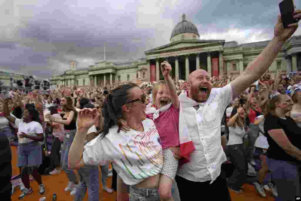England supporters celebrate in the fan zone in Trafalgar Square after Chloe Kelly scored their second goal during the final of the Women's Euro 2022 soccer match between England and Germany being played at Wembley stadium in London, July 31, 2022.
