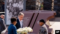 Secretary of State Antony Blinken and Antoinette Sithole, the sister of the late Hector Pieterson, right, lay a wreath at the Hector Pieterson Memorial in Soweto, South Africa, Aug. 7, 2022. 