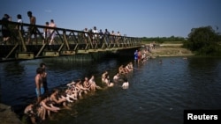 Bathers cool down in the River Thames, in Oxford, Britain, July 19, 2022.