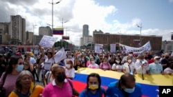 Trabajadores públicos activos y jubilados, incluidos maestros, protestan por mejores salarios y el resto de su bono de vacaciones que dicen fue pagado parcialmente, mientras marchan hacia el Ministerio de Trabajo en Caracas, Venezuela, el martes 2 de agosto de 2022. 