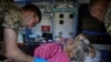 Ukrainian military paramedics attend resident Nina Trofimenko, 86, who was wounded during shelling near the frontline in the Donbas region of Ukraine amid Russia's attack on Ukraine, July 12, 2022.