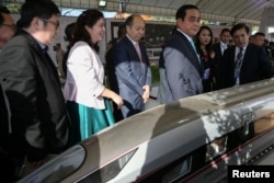 FILE - Thai Prime Minister Prayuth Chan-ocha stands next to a model high-speed train during the groundbreaking ceremony for cooperation between Thailand and China on the development of the Bangkok-Nong high-speed train Khai in Nakhon Ratchasima, Thailand on December 21, 2017.