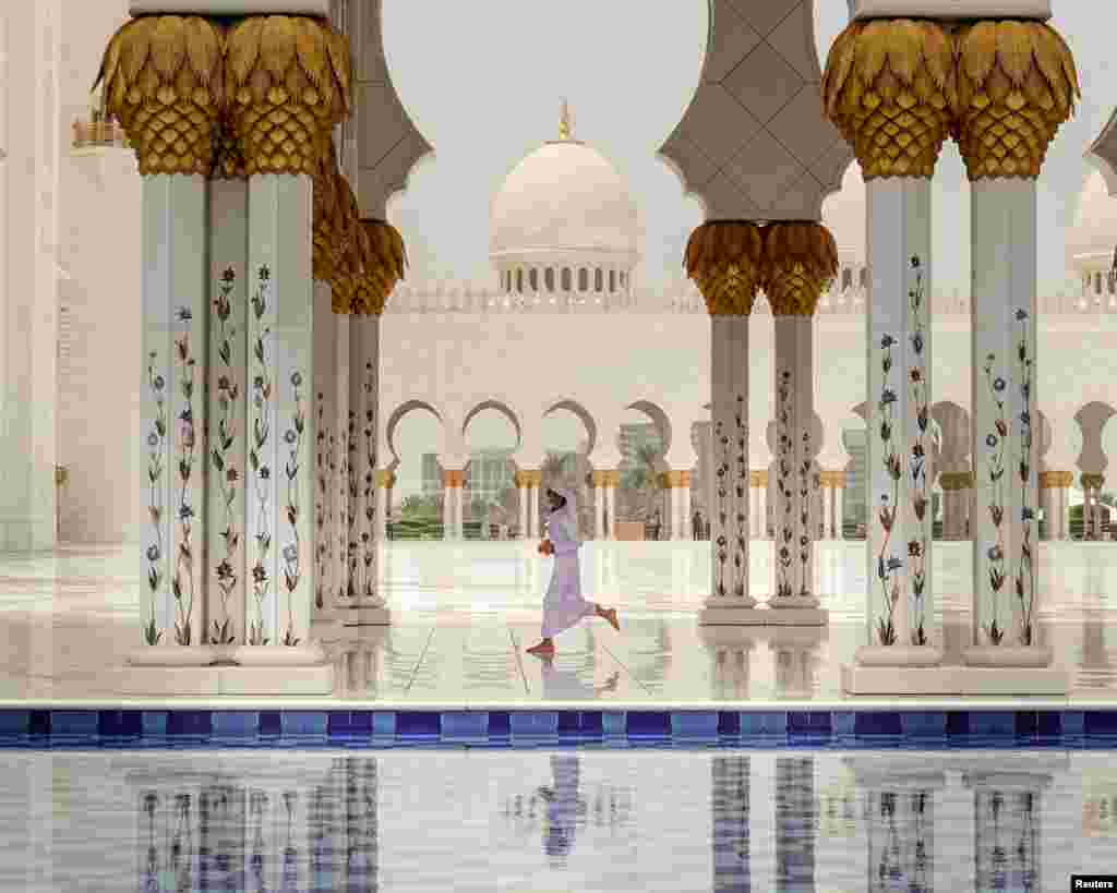 A child runs ahead of Friday prayer at the Sheikh Zayed Grand Mosque in Abu Dhabi, United Arab Emirates.