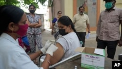 A health worker administers Covishield vaccine for COVID-19 at a vaccination center in Hyderabad, India, July 15, 2022.