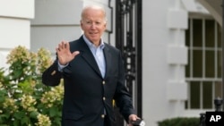 FILE - President Joe Biden waves as he walks to board Marine One on the South Lawn of the White House in Washington, Aug. 7, 2022. 