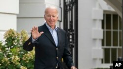 President Joe Biden waves as he walks to board Marine One on the South Lawn of the White House in Washington, on his way to his Rehoboth Beach, Del., home after his most recent COVID-19 isolation, Aug. 7, 2022. 