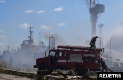 Firefighters work at a site of a Russian missile strike in a sea port of Odesa, as Russia's attack on Ukraine continues, Ukraine, July 23, 2022.