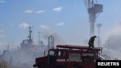 Firefighters work at a site of a Russian missile strike in a sea port of Odesa, as Russia's attack on Ukraine continues, Ukraine, July 23, 2022.