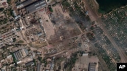 This satellite image from Planet Labs PBC shows the aftermath of a Ukrainian strike on a Russian ammunition depot in Nova Kakhovka, Ukraine, July 12, 2022.