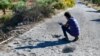 A man inspects the damage at the site where a U.S. drone strike killed Maher al-Agal, a leader in the Islamic State militant group, near the village of Khaltan, near Jindayris in northern Syria, on July 12, 2022.