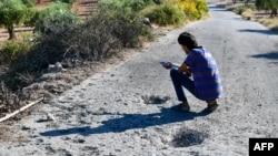 A man inspects the damage at the site where a U.S. drone strike killed Maher al-Agal, a leader in the Islamic State militant group, near the village of Khaltan, near Jindayris in northern Syria, on July 12, 2022.