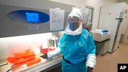 Microbiologist Annette Atkinson is pictured during a demonstration of how monkeypox is tested for at the Utah Public Health Laboratory, July 29, 2022, in Taylorsville, Utah.