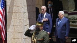 U.S. President Joe Biden and Palestinian President Mahmoud Abbas listen to the national anthem during a welcoming ceremony the West Bank town of Bethlehem, Friday, July 15, 2022. (AP Photo/Majdi Mohammed)