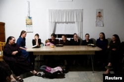 Members of the Harder family hold a meeting to say goodbye to other members of their family before moving to Campeche state in search of new land to farm, in the Mennonite community of El Sabinal, Chihuahua, Mexico, April 26, 2021. (REUTERS/Jose Luis Gonzez)