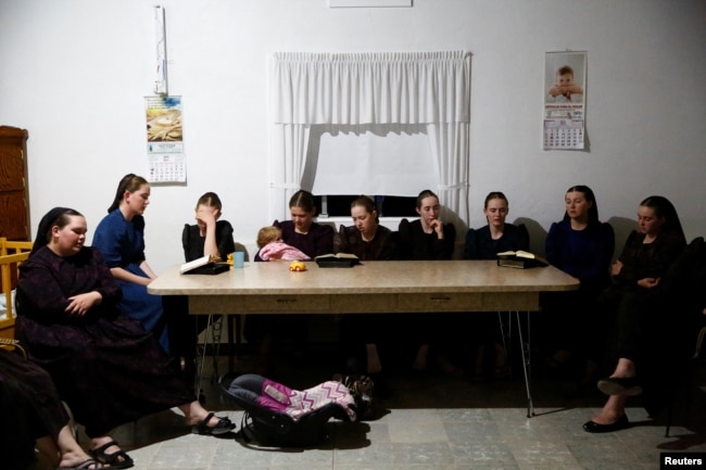 Members of the Harder family hold a meeting to say goodbye to other members of their family before moving to Campeche state in search of new land to farm, in the Mennonite community of El Sabinal, Chihuahua, Mexico, April 26, 2021. (REUTERS/Jose Luis Gonzez)